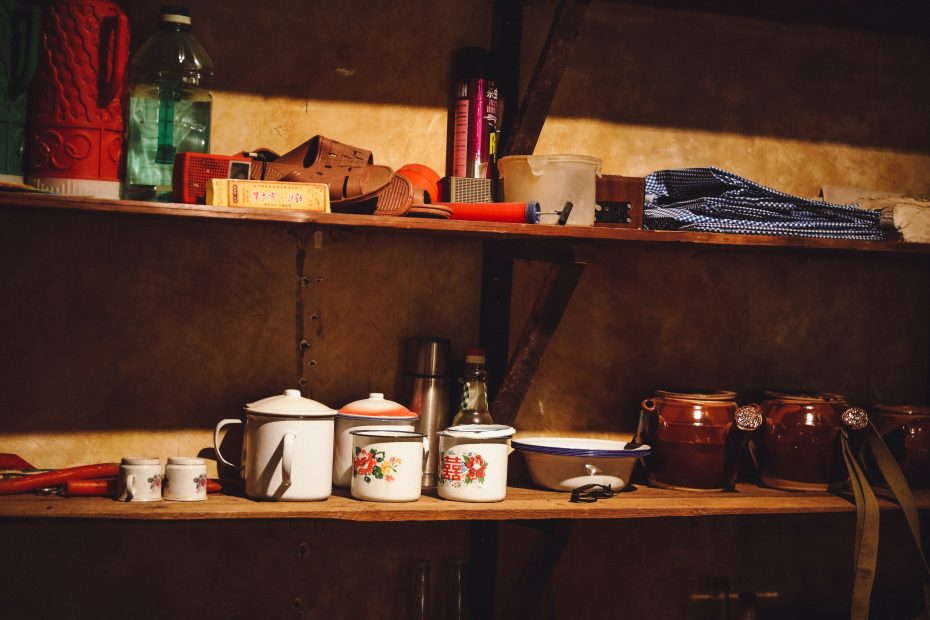 white ceramic cup on brown wooden shelf