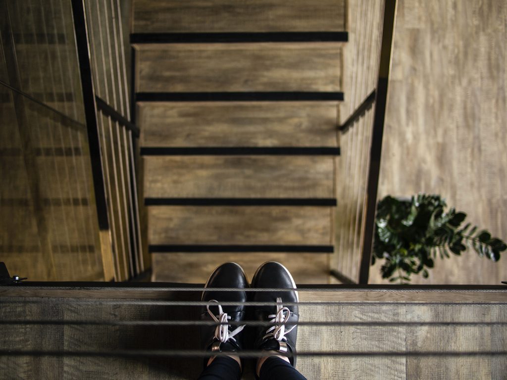 person standing near railing looking down