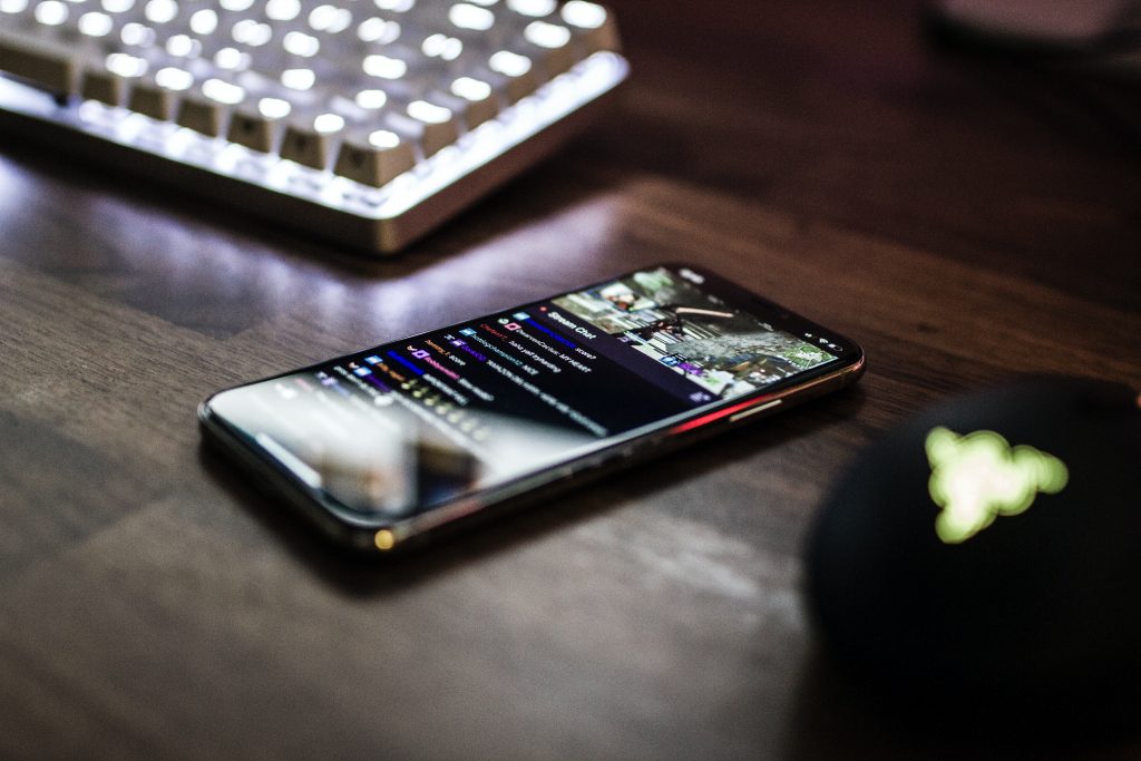 closeup photo of turned on smartphone near keyboard