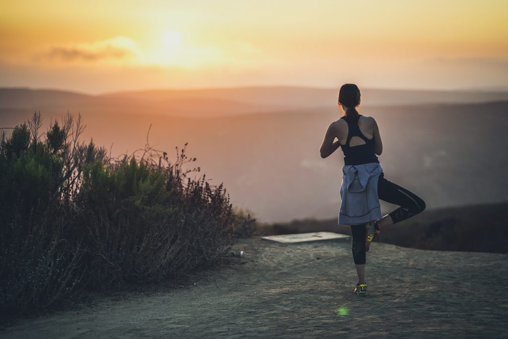 woman doing yoga post during golden hour