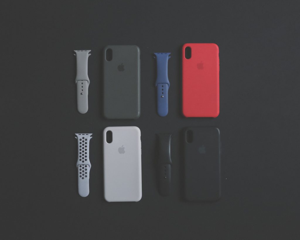 four assorted-color iPhone Xs cases and sports bands