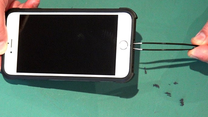 A Person cleaning iphone charging port