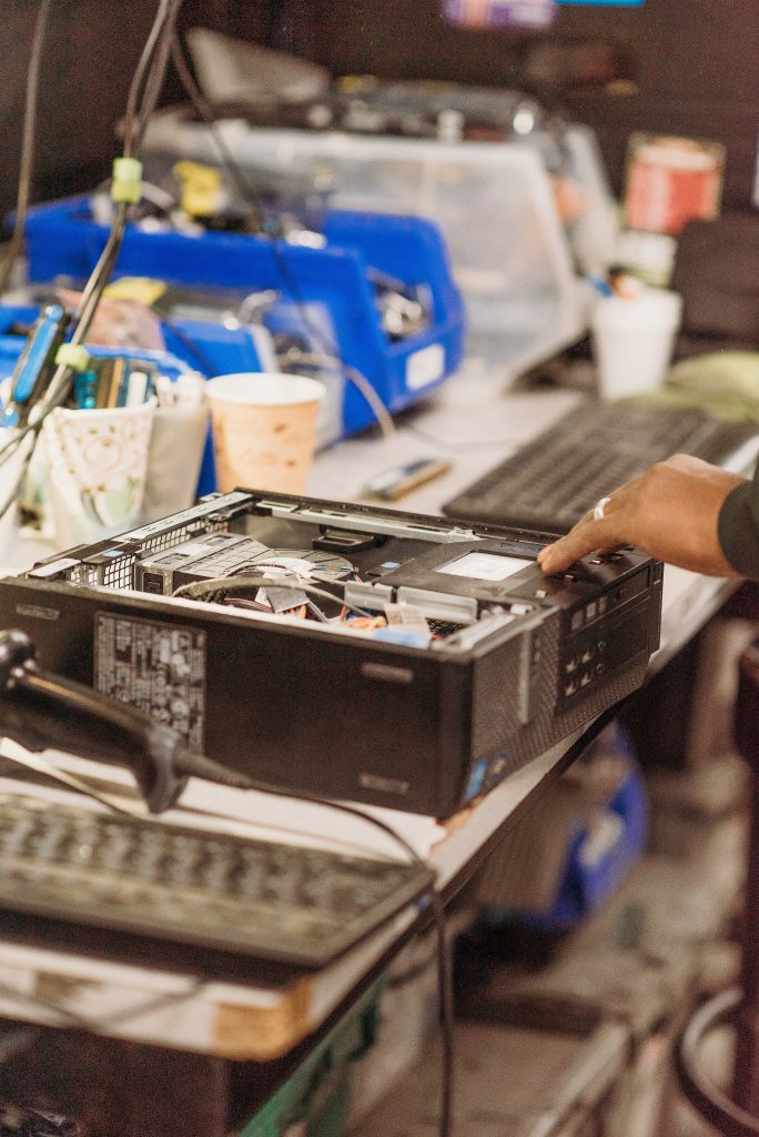 person dismantles recyclable tech