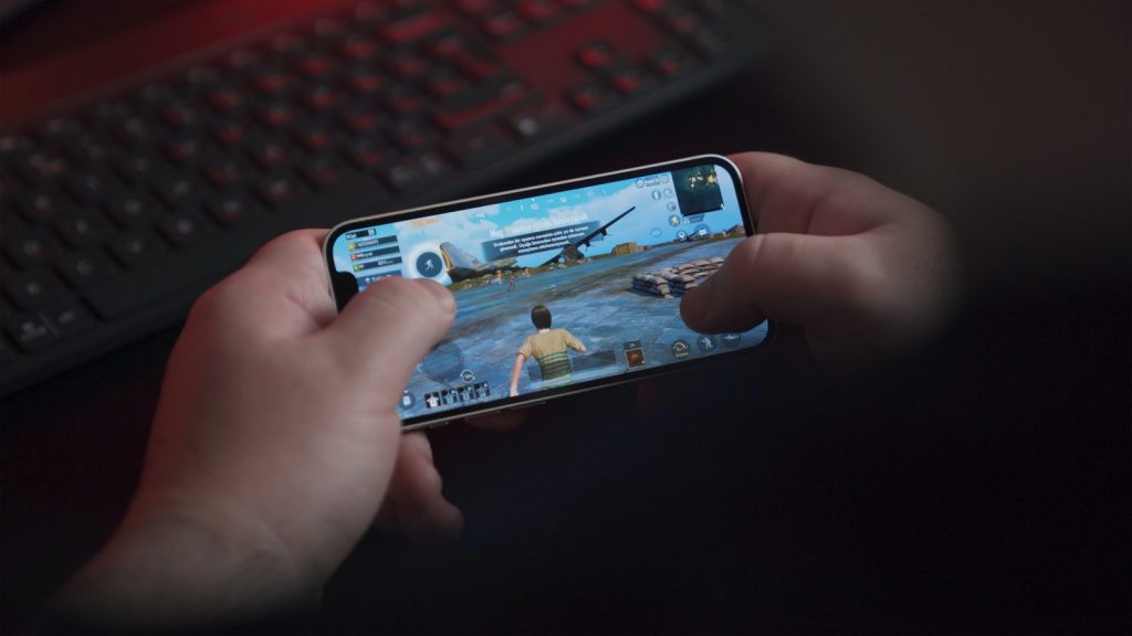 person playing game on iphone 